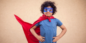 A boy dressed as a superhero