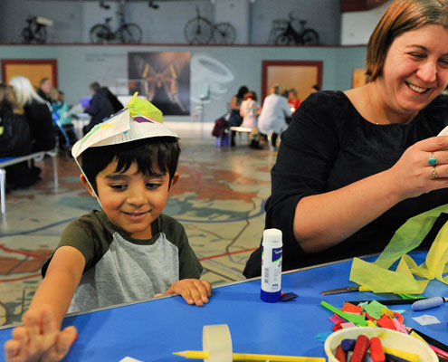 Child and parent crafting at Leeds City Museum with paper plates