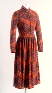 An orange patterned dress on a mannequin