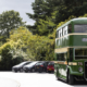 A green vintage bus is parked up in the carpark of Leeds Industrial Museum