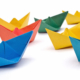 Brightly coloured paper boats