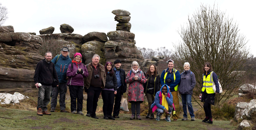 Leeds Art Gallery's Meet & Make group stand in front of some rocks at Brimham