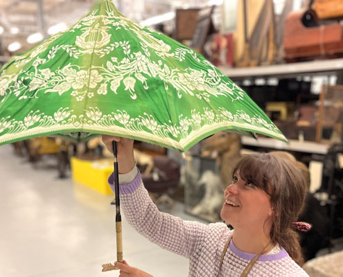 An umbrella being held by Assistant curator of dress and textiles at Leeds Discovery Centre
