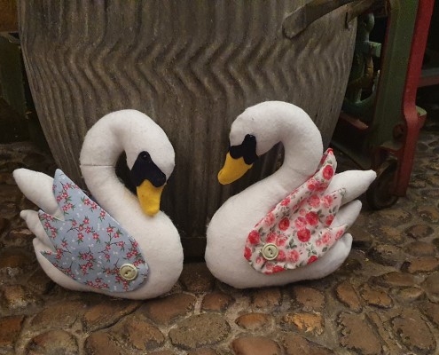Two toy swans in the Victorian street at Abbey House Museum