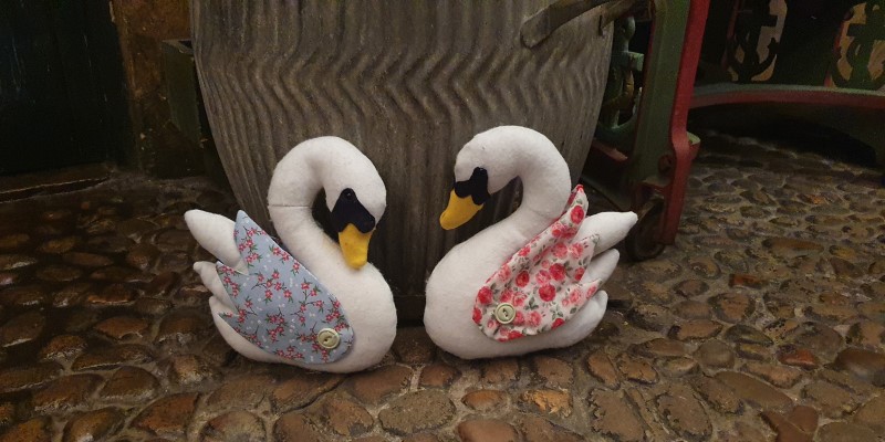 Two toy swans in the Victorian street at Abbey House Museum