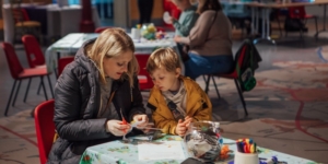 A mum and child doing crafts in the Brodrick Hall at Leeds City Museum