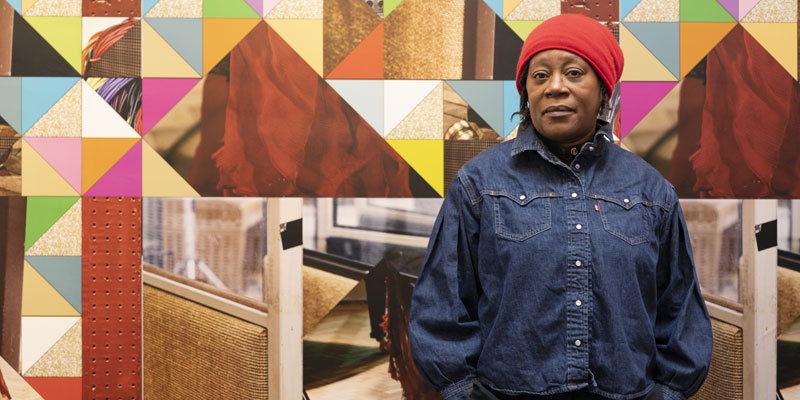 Artist Sonia Boyce stands in front of her video work