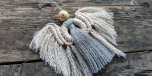 A Christmas tree decoration made from knotted cord in the shape of an angel.