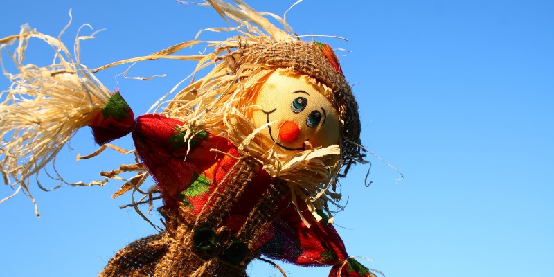 A scarecrow against a blue sky background