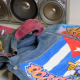 Two denim jackets which have been personalised with graffiti and images in bright colours, and a boom box in the background
