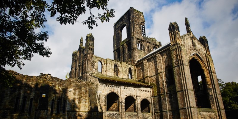 Kirkstall abbey with blue sky and clouds behind