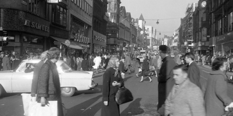 Black and white photograph of people on Briggate in Leeds in the 1950s