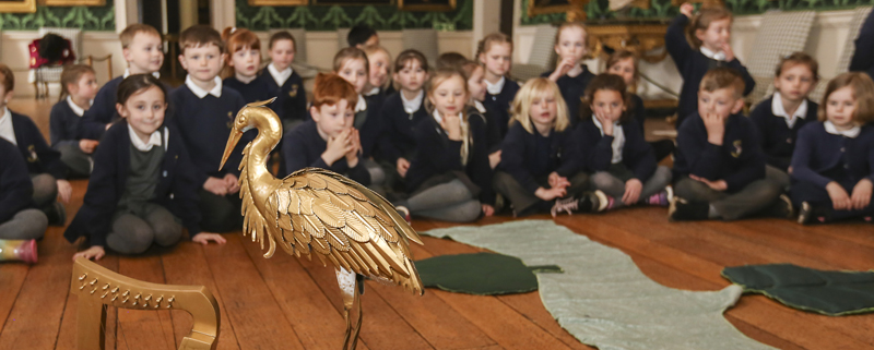 Children looking at a golden crane and harp in Temple Newsam House