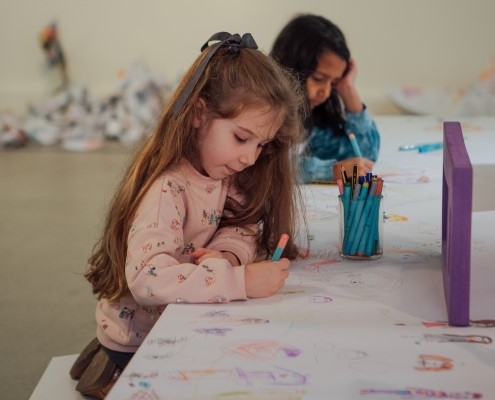 two children doing artwork in artspace