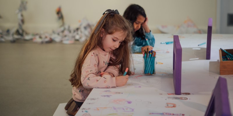 two children doing artwork in artspace