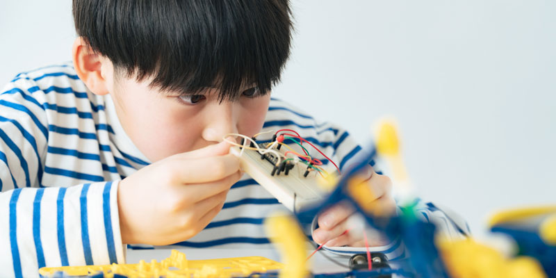 A young boy doing a coding activity