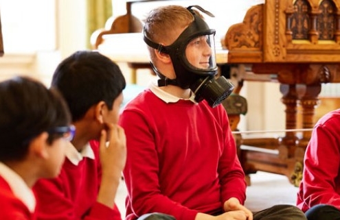 A group of schoolchildren at Lotherton, one is wearing a gask mask as part of the workshop