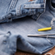 Jeans being patched up with sewing items