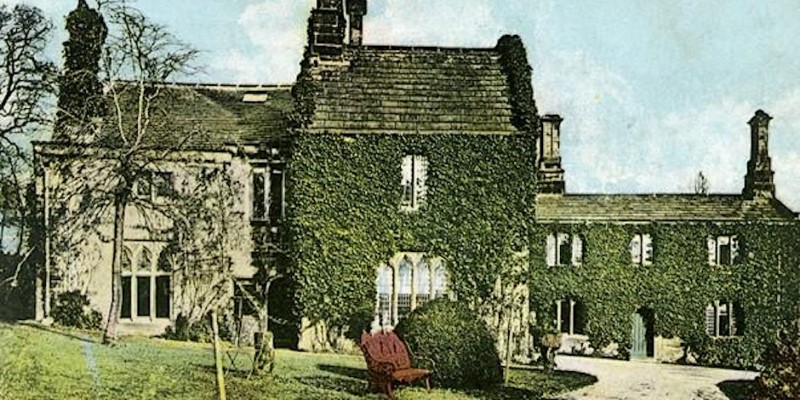 Old photograph of abbey house museum covered in ivy