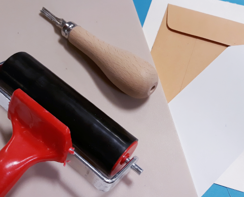 Paint roller, paper, crafting materials