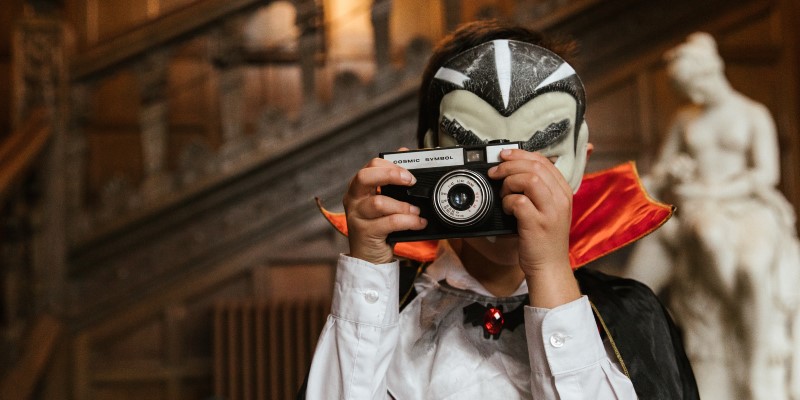 person dressed up as Dracula taking a photo