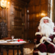 father christmas at temple newsam with a christmas tree in the background