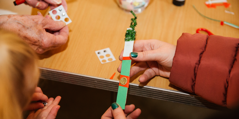 adult and child hands doing christmas craft activities