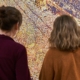 two people looking at a golden shiny artwork