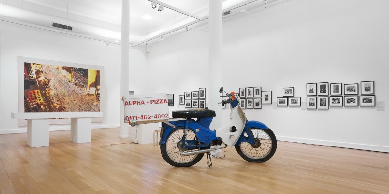 moped in teh foreground with artworks in the walls behind