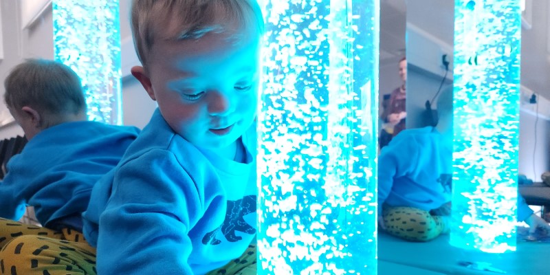 child with a light up bubble tube