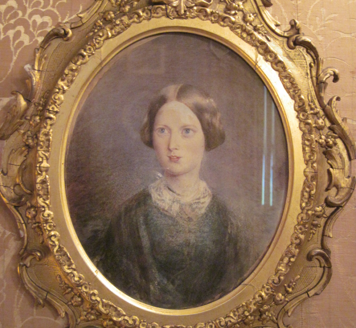 An ornate frame with a painting of a Victorian Woman