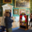 A family in the Picture Gallery of Temple Newsam setting up a photo using the puppet show stage