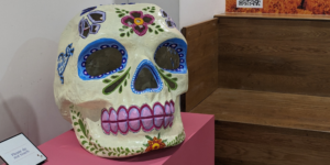 a large model of a skull decorated with flowers and brightly coloured patterns